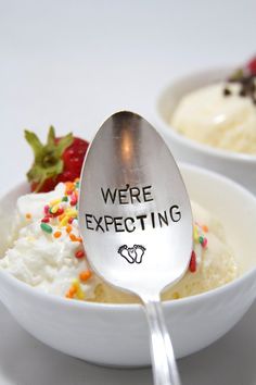 two bowls with ice cream and strawberries in them that say we're expecting