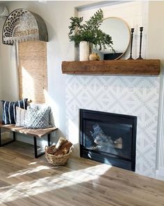 a living room filled with furniture and a fire place in front of a wall mounted mirror