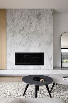 a living room with a fireplace and white walls