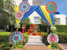 an outdoor ceremony area decorated with colorful decorations