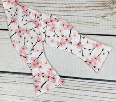 "Pale pink cherry blossoms on white cotton sateen. Because of the handmade nature of these bowties they can vary in size ever so slightly but on average the bow measures 5 inches by 2 inches when tied. hand wash/ spot wash only The self-tied option will be made in the style pictured. The pre-tied option will have the addition of a hook in the back, and the bow will be stitched in the tied position. RETURNS: I accept returns on items in original, unused condition. You will receive a refund for th Elegant White Bow Tie For Spring, White Satin Bow Tie For Spring, Pink Bow Tie For Spring Formal Occasions, Pink Bow Tie For Spring Formal Events, Muscular Neck, Mens Bowtie, Cherry Blossom Wedding, Cherry Blossom Festival, Pink Cherry