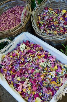 three baskets filled with different types of flowers