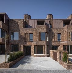 a brick building with many windows and balconies