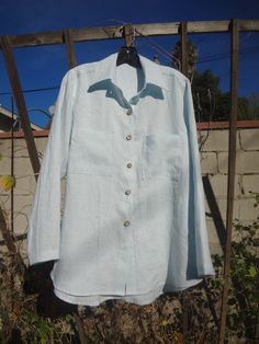 "Our long-sleeve linen shirt with shirttail hemline. Relax Fit .Wood Buttons at front placket . Hemline is slightly longer in the back. 100% linen and 2 pockets. Ligth baby blue color and see color card. I use 100% linen and is pre-washed to remove shrinking. My designs are made in California. Washed linen is chic and creases with style. It becomes softer and durable with each wash. Tip- don't iron your linen, leave it to have a lovely wrinkle for more natural look. SIZE MEDIUM : GARMENT FINISH Long Sleeve Linen Shirt With Placket, Flax Long Sleeve Relaxed Fit Blouse, Flax Colored Long Sleeve Relaxed Fit Blouse, Relaxed Fit Long Sleeve Blouse In Flax Color, Flax Long Sleeve Shirt With Button Closure, Relaxed Fit Long Sleeve Flax Blouse, Linen Shirt With Pockets And Shirttail Hem, Long Sleeve Flax Shirt With Button Closure, Linen Blouse With Pockets And Shirttail Hem