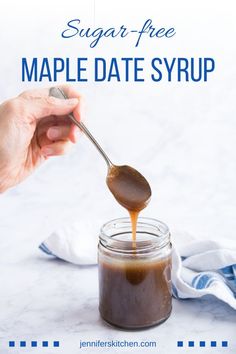 a spoon full of maple date syrup being drizzled on top of a jar