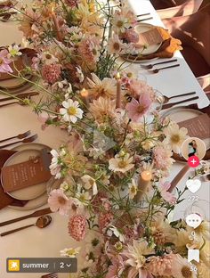 the table is set with white and pink flowers