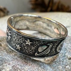 This Solid Sterling Silver Crescent Moon & Stars ring with an entire tiny universe on the band. The ring is adorned with an intricate celestial detail that goes all around the band - an artful rendition of the traditional design. Oxidized finish combines with polished detailing lets the tiny moons, stars, planets and sun stand out. Meticulously crafted from fine sterling silver with beautiful detailing, this Celtic Moon & Stars ring showcases the beauty of Celtic tradition, modern design, and fi