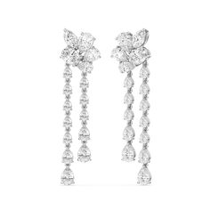 The Mosaic Chandelier Earrings are a masterpiece made to captivate the senses. This delicate pair of earrings features a radiant post formed by a cluster of pear and marquise cut diamonds. Twin linear drops detailed with pear-cut diamonds in tapering sizes suspend from the post, gently swaying and sparkling as you move. Elegant Cluster Earrings With Sparkling Stones, Elegant White Cluster Bridal Earrings, Elegant Cluster Earrings With Sparkling Details, Royalty Accessories, Blue Wedding Band, Rain Lily, Cluster Chandelier, Something Blue Wedding, Gorgeous Engagement Ring