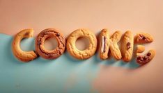 the word cookie spelled out with cookies in front of it on a blue and pink background