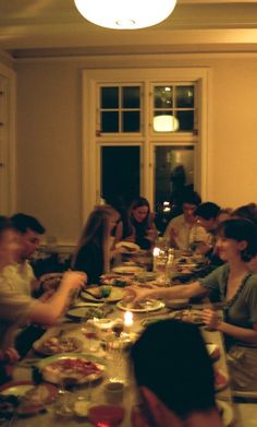 a group of people sitting around a dinner table