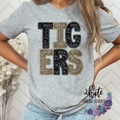 Pick yourself up one of these fun and spirit-filled Tigers spirit shirts. This shirt is sure to impress your friends and make them want one for themselves.  It's a very soft shirt in an athletic heather (gray) color. The shirt is made of 95% polyester but has a cotton feel.  This shirt is a digital print of sequins. These are not real sequins. There is no 3D feeling to the shirt. It is printed directly onto the shirt.  To get the best wear from your shirt make sure to  1. Wash in cold water 2. Tumble dry low 3. Do not iron on design area 4. Do not use fabric softener unisex sizing. School Spirit T-shirt For Cheerleading In Fall, Casual Glitter Print Tops For Cheerleading, Casual Fall T-shirt With Sequins, Casual Sequined T-shirt For Fall, Short Sleeve Tops With Glitter Print For Game Day, School Spirit Glitter Print Crew Neck T-shirt, Casual Game Day T-shirt With Glitter Print, Casual T-shirt With Glitter Print For Game Day, Casual Glitter Print T-shirt For Game Day