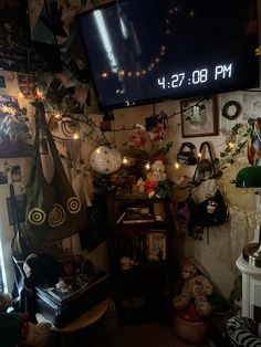 a room filled with lots of clutter and decorations on the wall next to a flat screen tv