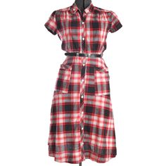 40s Vintage Red Black White Plaid Short Sleeve A Line Cotton Midi Dress Details: - white plastic buttons down entire front - classic 1940s A line dress - quilted piping vertical dress edging entire length of dress - large patch pockets trimmed in same quilted piping - gathered shoulder seams over bust area - split short sleeves held together with matching button - bodice meant to lightly blouse as result of front bodice waist pleats - 1950s belt included but not original to the dress - best for Quilt Dress, Vintage 40s, Cotton Midi Dress, 50s Fashion, Day Dress, Brand Tags, White Plaid, Dress Clothes For Women, Cotton Dress