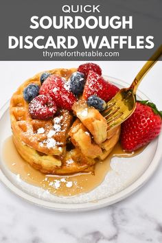 a white plate topped with waffles covered in syrup