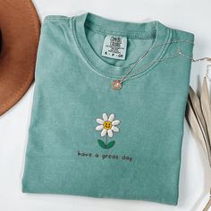 Comfort Colors Embroidered Flower T-Shirt, Cute Floral Shirt, Flower Embroidered Shirt, Have a great day Shirt, Smiley Face Shirt This embroidered flower comfort colors shirt is everything. Perfect to wish everyone a great day! ✨ 100% Cotton ✨ Pre-shrunk ✨ Relaxed fit Care: Machine wash: warm (max 40C or 105F) Tumble dry: low Do not iron directly on the print REFUNDS AND EXCHANGES All items are made to order using multiple suppliers to ensure quick worldwide shipping. For this reason we are unab Embroidered Raccoon, Texas State Flag, Smiley Face Shirt, Etsy Clothes, Silly Shirt, Texas Shirt, Raccoon Shirt, Kaftan Designs, Funny Raccoon