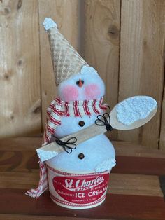 a snowman made out of an ice cream cup