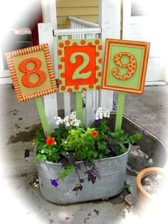 a potted plant with flowers and numbers on it