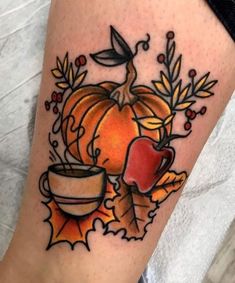 a tattoo with an apple, cup and leaves on it