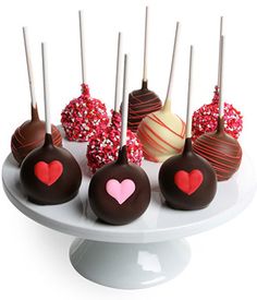 there are many chocolates on the plate with hearts and sprinkles in them