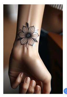 a woman's foot with a flower tattoo on it