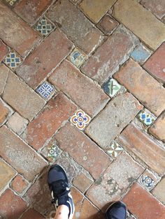 a person standing on top of a brick floor