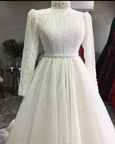 a white wedding dress on display in a store