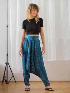 "An extraordinary pair of vintage KENZO baggy harem pants that will not go unnoticed! Crafted from viscose fabric with an extra soft touch, in beautiful azure blue with paisley and floral print. The trousers feature high waist, side pockets and pleat front. You can discover hues of blue, green, yellow and red if you look close enough. Fantastic boho design! Button and zipper closure. Made in France Material: 100% viscose Condition: excellent Size: best fits size XS (size on tag: 40, but consider Blue Baggy Harem Pants With Elastic Waistband, Baggy Blue Harem Pants With Elastic Waistband, Cotton Wide Leg Bottoms With Paisley Print, Wide Leg Cotton Bottoms With Paisley Print, Blue Paisley Print Casual Bottoms, Blue Baggy Harem Pants With Tapered Leg, Blue Harem Trousers With Elastic Waistband, Blue Harem Pants With Elastic Waistband, Tapered Leg, Blue Tapered Leg Harem Pants With Pockets