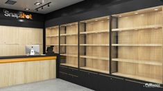 an empty store with wooden shelves and black walls