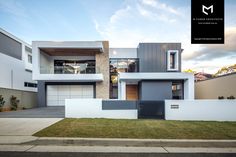 a modern house with two story windows and white walls