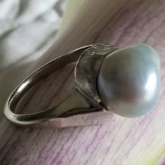 "* This beautiful pearl ring would be a wonderful gift to a bride on her wedding day, or perhaps the mother of the bride or groom! The silvery gray pearl is is unique and beautful, giving this ring tons of understated charm and elegance. This ring is very sturdy and well-made, and it shows! * This piece weighs 6.7 grams, and is stamped \"14K\" inside the shank. The pearls measure approximately 12.6 mm x 12.9 mm This ring is a US size 7. Please message us about sizing options prior to purchase! * Silver Oval Pearl Ring With High Luster, Silver High Luster Pearl Ring For Anniversary, White Gold Pearl Ring With High Luster For Wedding, Unique Polished Pearl Ring For Wedding, Silver Pearl Ring With Polished Finish For Wedding, Modern Silver Pearl Wedding Ring, Silver Pearl Ring With High Luster For Gift, Unique Wedding Pearl Ring With Polished Finish, Formal Silver Pearl Ring With High Luster