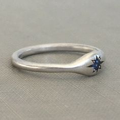 Signet ring with a hand engraved star and bead set blue sapphire. Wear it as a signet ring, or it could be a non-traditional engagement ring, one that's low profile and easy to wear. Choose sterling silver or 14k gold with a blue sapphire. DETAILS - 2.2 mm blue sapphires vary in color from light to dark blue. Add a note if you have a preference on tone. - Choose 14k rose, yellow or palladium white gold or sterling silver - nickel free - 14k palladium white gold is a medium grey color and is not Celestial Sapphire Birthstone Ring For Anniversary, Celestial Sapphire Anniversary Ring With Birthstone, Hand Forged Sterling Silver Sapphire Promise Ring, Star Shaped Sapphire Ring For Anniversary In Sterling Silver, Celestial Sterling Silver Sapphire Promise Ring, Celestial Star Sapphire Ring For Anniversary, Traditional Engagement Rings, Sapphire Wedding, Hammered Rings