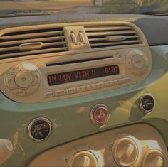 the dashboard of a car with an electronic clock on it's dash board and radio