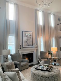 a living room filled with furniture and a fire place in the middle of a room