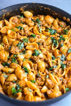 pasta with meat and spinach in a skillet on the counter top, ready to be eaten