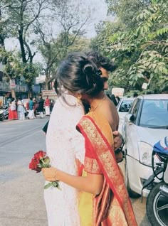 two women standing next to each other on the street