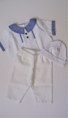 This adorable outfit is made with quality material for the little prince. The top is made with white cotton. Short is very comfortable for the baby, it has elastic on the waist. The outfit are made for a baby boy, outfit can be use to take everywhere and for his first picture! . Top has buttons down the back. This set has adorable design with blue buttons on front and on the sides of the short. All handmade ** Eyelets are made also by hand too Cream Cotton Short Sleeve Sets, Cream Cotton Sets For Baptism, Fitted Cotton Sets For Playtime, White Cotton Sets For Baptism, White Cotton Baptism Sets, White Cotton Short Sleeve Sets, Cotton Baptism Sets, Fitted White Cotton Sets, White Fitted Cotton Sets