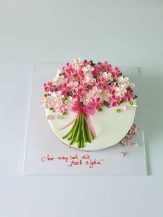 a cake decorated with pink flowers on top of a white plate