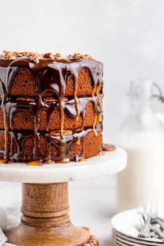 a cake with chocolate icing and nuts on top