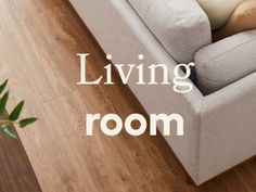 a living room with a couch, chair and plant on the floor that says living room