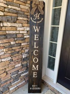 a wooden welcome sign with a bow on it