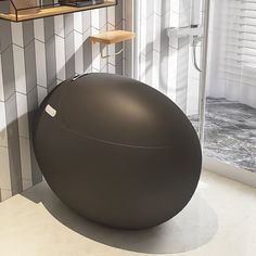 a bath room with a large ball on the floor and a shower head mounted to the wall