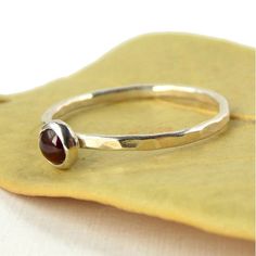 Garnet Hammered Band Stacking Ring - 925 sterling silver ring with 4mm red garnet cabochon - Stackab Adjustable Round Garnet Ring, Garnet Birthstone Ring With Round Band As Gift, Garnet Birthstone Ring Gift, Adjustable Garnet Ring, Round Cabochon Garnet Jewelry, Round Garnet Cabochon Jewelry, Red Birthstone Stackable Rings, Polished Finish Birthstone Ring As Gift, Birthstone Ring With Polished Finish For Gift