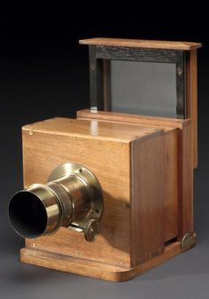 an old fashioned wooden camera on display