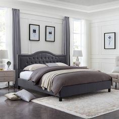 a bedroom with white walls and gray furniture