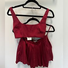 New With Tags, Never Worn. Red/Maroon Satin Two Piece Set With Bralette Style Crop Top And Pleated Skirt. Bought For A Bachelorette Party And Never Ended Up Wearing. Super Cute. Red Sleeveless Two-piece Set, Two-piece Red Summer Sets, Red Two-piece Sets For Summer, Casual Red Party Sets, Chic Red Sets For Night Out, Cropped Two-piece Party Top, Cropped Two-piece Top For Party, Casual Two-piece Crop Top Set For Party, Red Sleeveless Matching Set