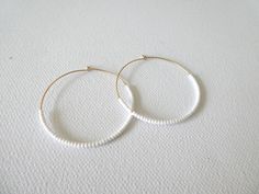 These hoops are gold filled and they have dainty and high quality white seed beads. Also available with sterling silver, 14kt gold and 14kt rose gold (choose preference at checkout). ❤ SIZES They measure 45 mm in diameter. ❤ PROCESSING AND SHIPPING Most orders are made and shipped out in one business day. Please check delivery timeframes for your location on the description below. ❤ CUSTOM ORDERS Contact me to discuss you needs! Go back to my shop: https://www.etsy.com/shop/StephanieMartinCo See White 14k Gold Filled Hoop Earrings, White 14k Gold Filled Hoop Jewelry, Handmade White 14k Gold Filled Hoop Earrings, Handmade 14k Gold Filled White Hoop Earrings, Minimalist White Hoop Earrings For Everyday, White Diamond Hoop Earrings, White Round Bead Earrings For Everyday, Handmade White Beaded Earrings For Everyday, Minimalist Small Hoop White Jewelry