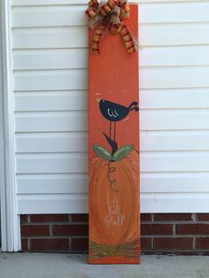 a painted pumpkin with a black bird on it