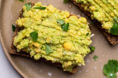 an avocado toast on a plate with cilantro