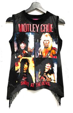 One of a kind Motley Crüe womens top. Faux stretch sealskin fabric detailing on collar, armholes and fabric.  Black fringe on back. Exposed lower back Size Small  Bust- 34 inch circumference  Length- 22 inches Sleeveless Fringe Tops For Night Out, Punk Sleeveless Tops For Fall, Stretch Sleeveless Top For Concert, Sleeveless Stretch Tops For Concert, Sleeveless Grunge Party Top, Rebellious Fitted Graphic Print Tops, Alternative Sleeveless Tops For Night Out, Alternative Style Sleeveless Tops For Night Out, Grunge Sleeveless Top For Night Out