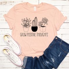 a t - shirt that says grow positive thoughts with two potted cacti